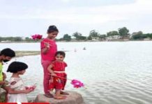Little hands shed dolls in water, Guddi Bolavani festival